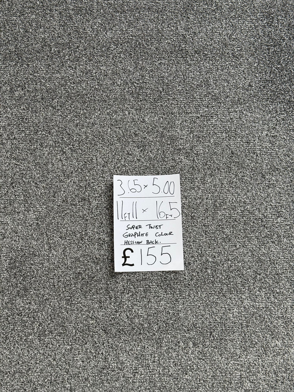 Gray textured fabric carpet with a price tag attached